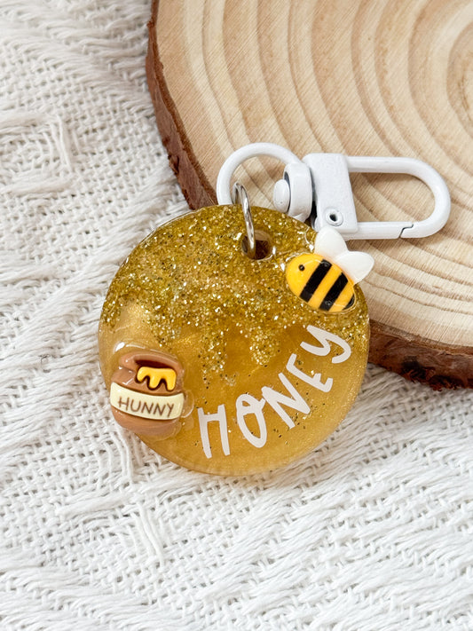 Round golden yellow resin pet tag with honey and bee 3D design, personalized with pet's name and phone number for dogs and cats
