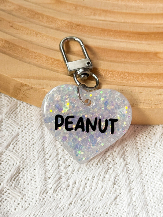 Heart-shaped white resin pet tag with white sparkle and glitter, personalized with pet's name and phone number for dogs and cats